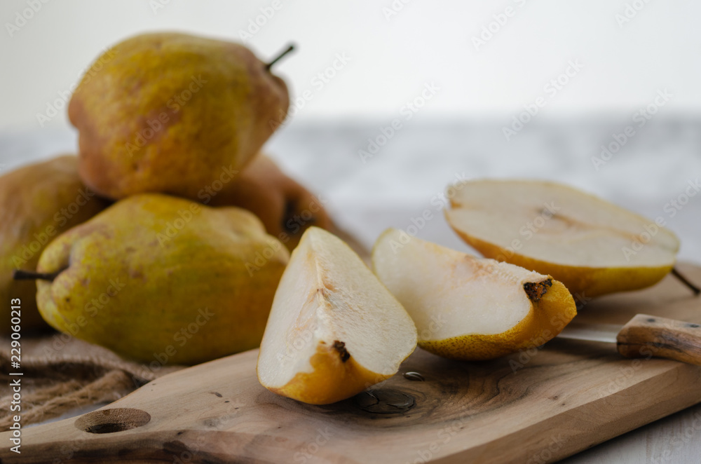 Fresh ripe organic yellow pears  on rustic wooden table,