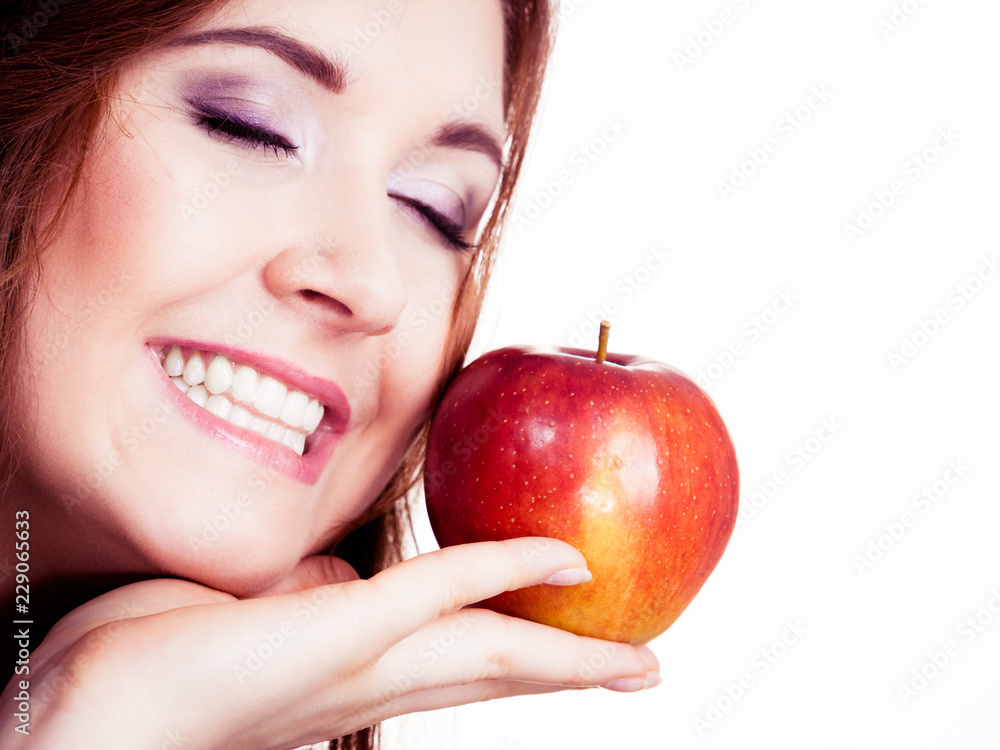 Woman holds apple fruit close to face, isolated Woman holds apple fruit close to face, isolated