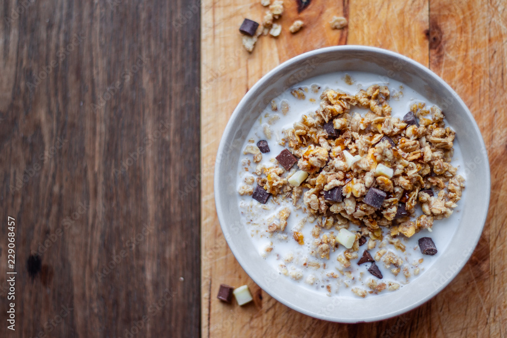 Bowl of chocolate muesli and milk on dark background Bowl of chocolate muesli and milk on dark background