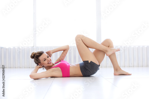 Fitness woman doing exercises on the press top view.
