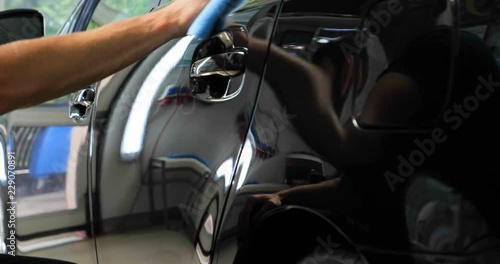 Two specialist dries the car from moisture, car washing. Concept: Drying Machines, Professionals, Auto Service.