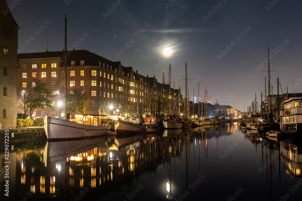 Fototapeta premium Cozy christianshavn channel in the danish capital of Copenhagen. This is the harbor for many liveaboard and boats made for housing