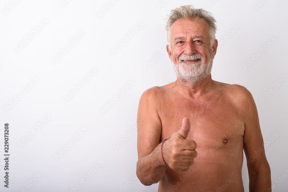 Fototapeta premium Happy senior bearded man smiling while giving thumbs up