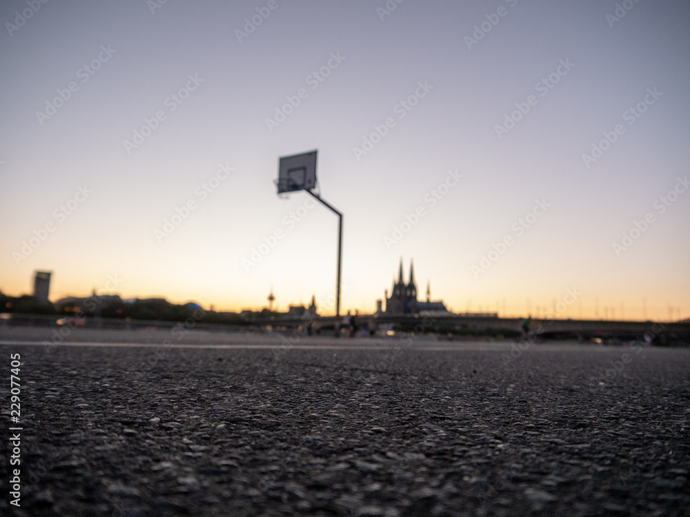 Urban Basketball hoop with skyline of Cologne, Germany, in background