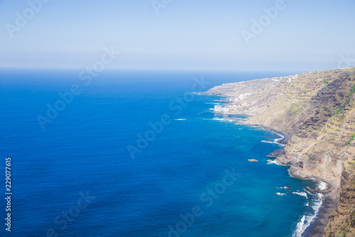 island in the ocean. coast and beach from a height of flight. shore by the sea, beautiful blue sky