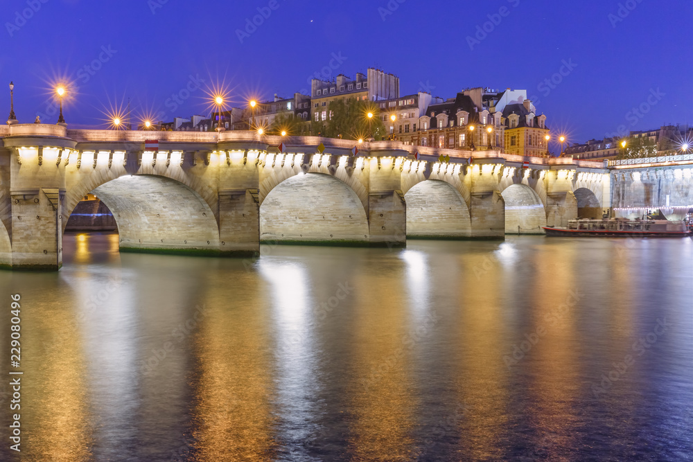 Night view of Ile de la Cite and Pont Neuf in Paris, France