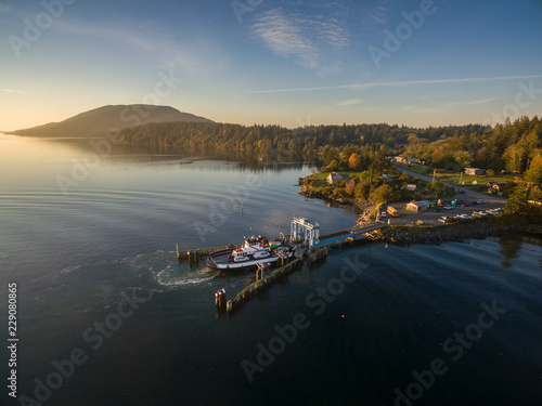 Pacific Northwest Ferry Boat Docked During Sunrise. Aerial view of the Lummi Island ferry, "Whatcom Chief", at home during a glorious autumn sunrise. © LoweStock