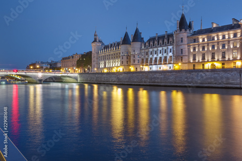 Beautiful view of Seine and Conciergerie at night in Paris, France