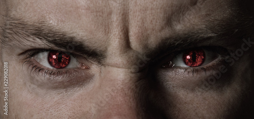 Red angry devil eyes closeup
