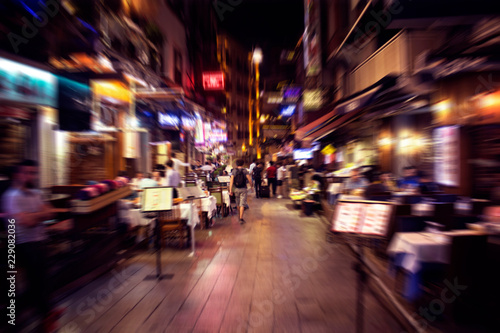 Blurry motion image of people walking on a street in Taksim /Beyoglu area at night in Istanbul. Location is a busy nightlife, shopping and dining district.