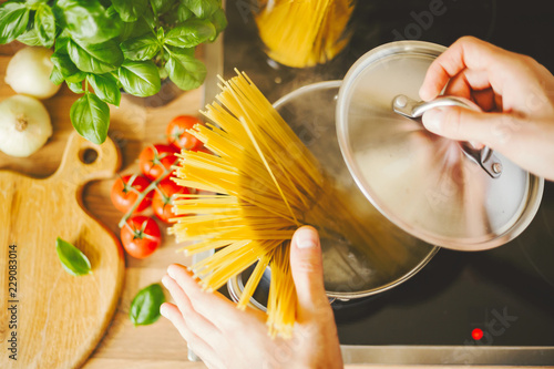 Man holding spoon with steaming pasta