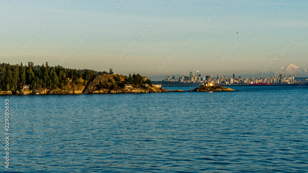 Downtown Vancouver, beautiful British Columbia, Canada, seen from the ferryboat, snowy peak of Mount Baker in the background.