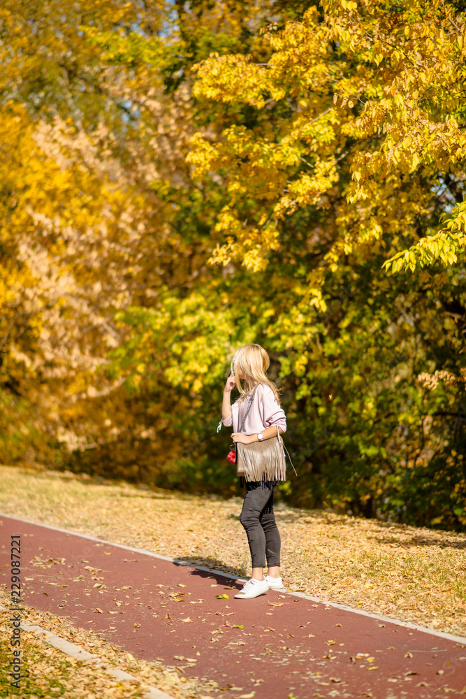 Photographing a girl during autumn in a park with a blurred background Photographing a girl during autumn in a park with a blurred background