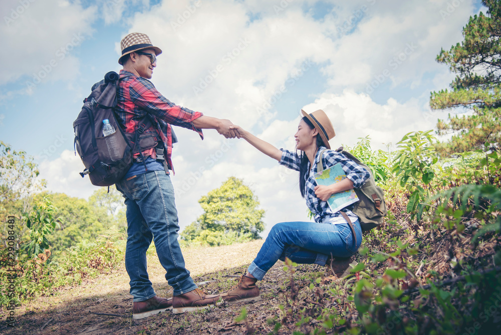 © EKKAPON - Young attractive couple hiking in the forest. © EKKAPON - Young attractive couple hiking in the forest.
