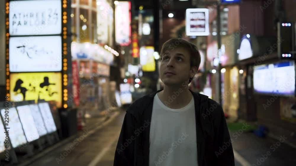 Slow motion - Tourist walks through Shinjuku district. Tokyo, Japan Slow motion - Tourist walks through Shinjuku district. Tokyo, Japan