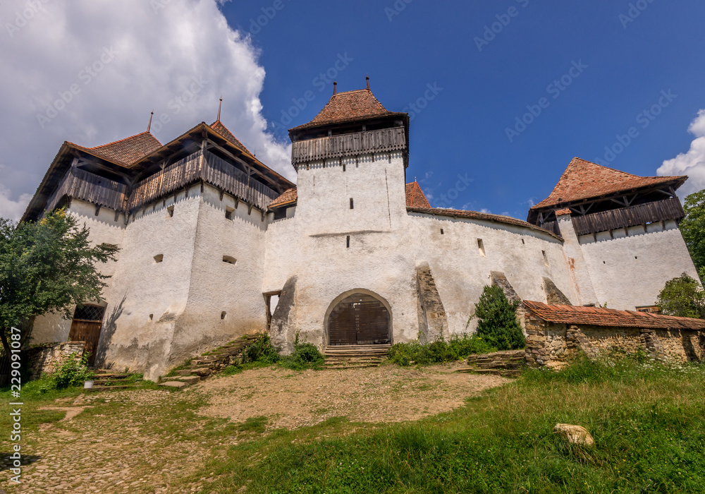 Summer view of UNESCO medieval fortified church of Viscri Romania