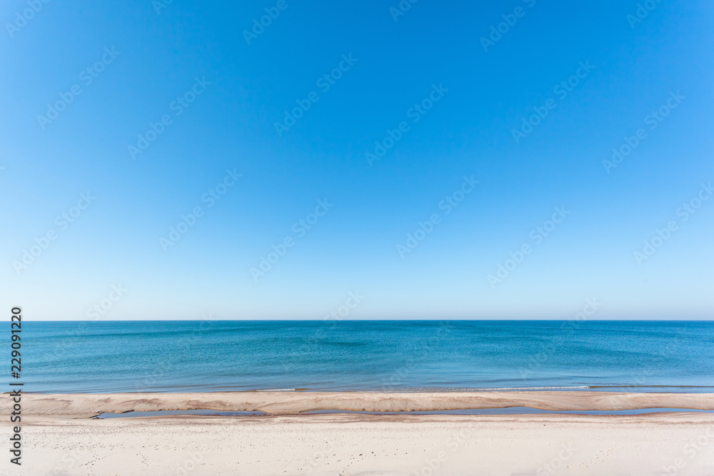 Fototapeta premium bright wild beach of white sand by the blue sea