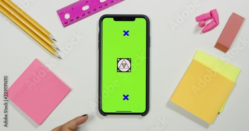 Using a green screen phone on a white work arts and crafts desk