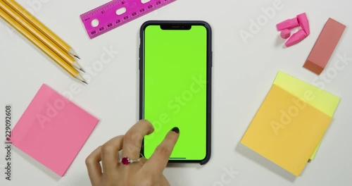 Using a green screen phone on a white work arts and crafts desk
