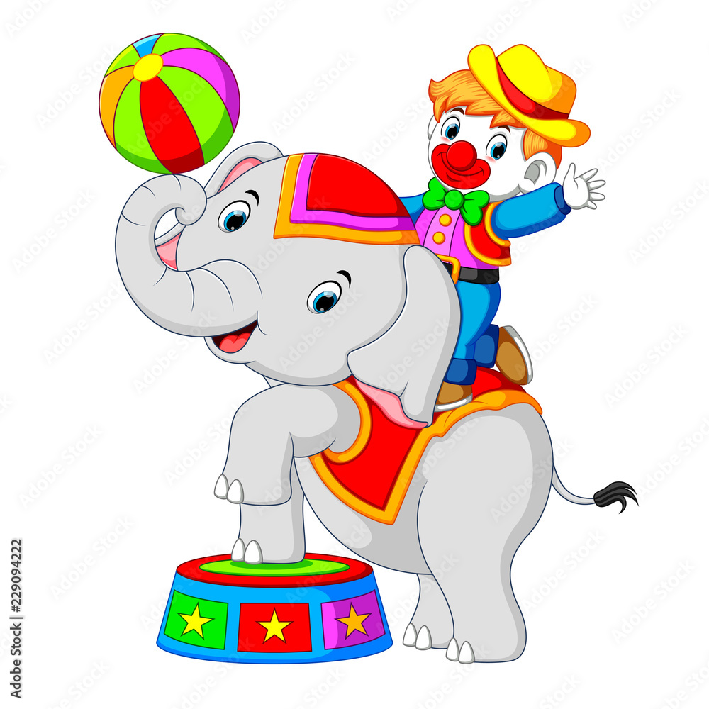 Fototapeta premium a boy uses a clown costume with an elephant while playing circus 