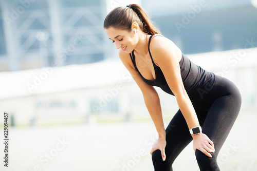 Sport outdoor. Woman Listening Music On Phone While Exercising Outdoors