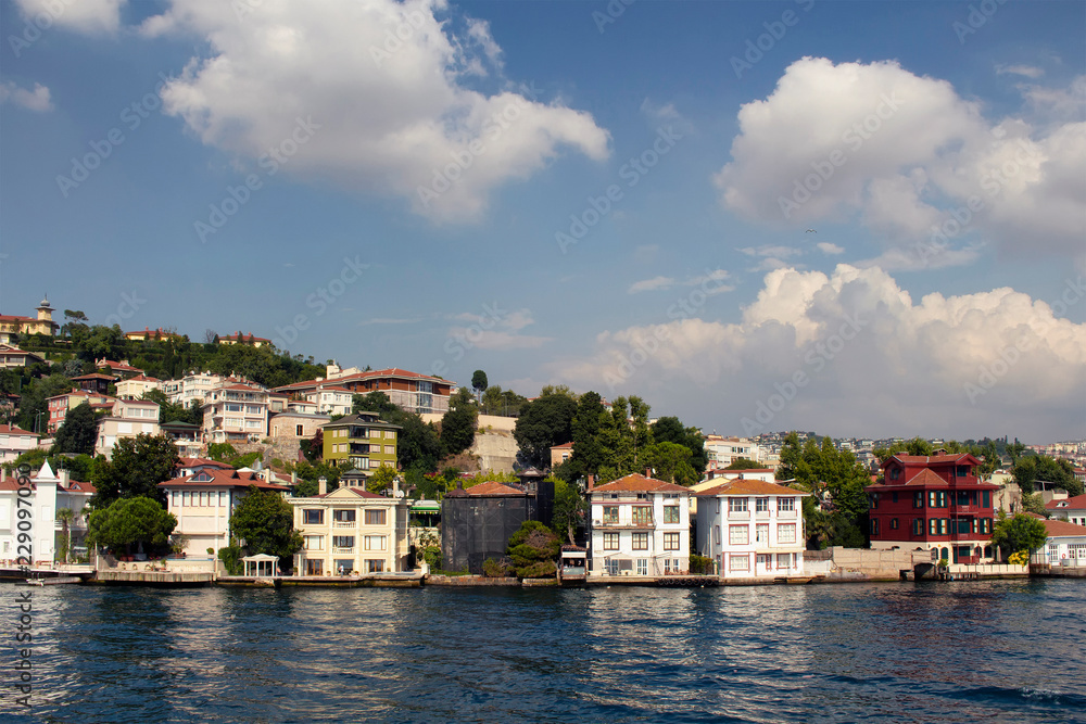 View of historical, old Turkish / Ottoman houses by Bosphorus on Asian side of Istanbul. It is a sunny summer day.