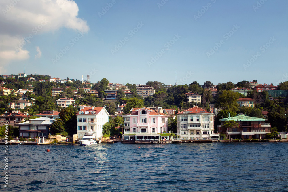 View of houses and buildings by Bosphorus on the Asian side of Istanbul. It is a sunny summer day.