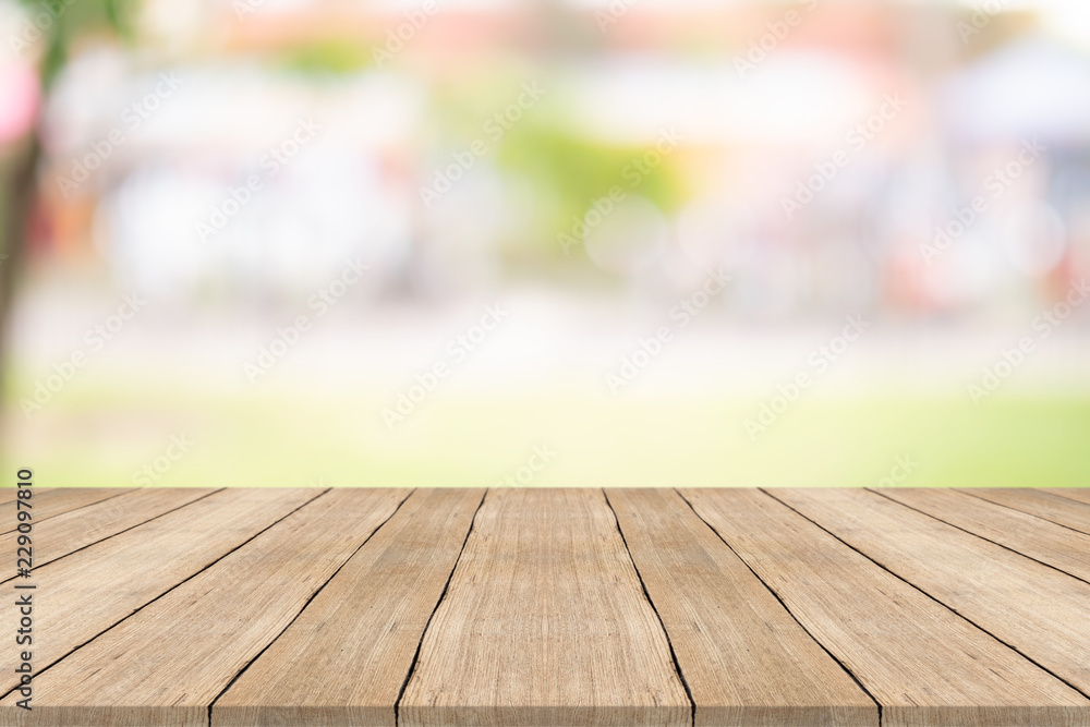 Wood table top on blurred background at garden,for montage your products Wood table top on blurred background at garden,for montage your products