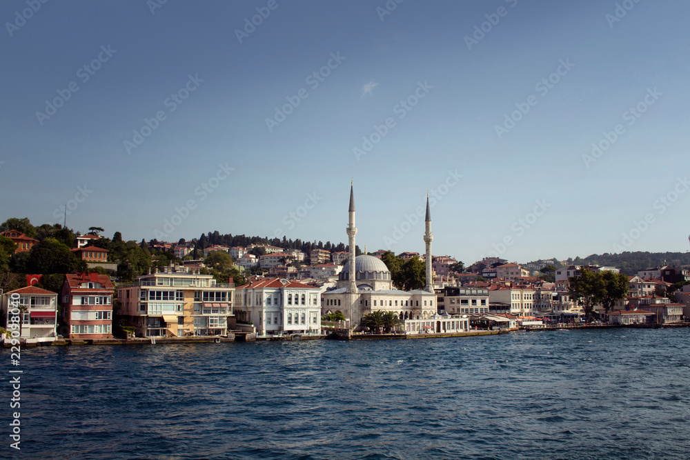 View of houses, mosque and buildings by Bosphorus on the Asian side of Istanbul. It is a sunny summer day.