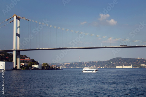View of a tour boat, Bosphorus bridge, European and Asian sides of Istanbul.