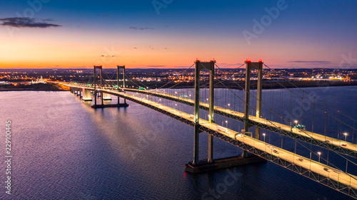 Aerial view of Delaware Memorial Bridge at dusk. The Delaware Memorial Bridge is a set of twin suspension bridges crossing the Delaware River between the states of Delaware and New Jersey photo