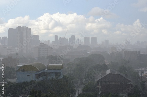 Photography Heavy rain in day time with sunlight that can still can see blue sky and white clouds in the monsoon season of Bangkok Thailand