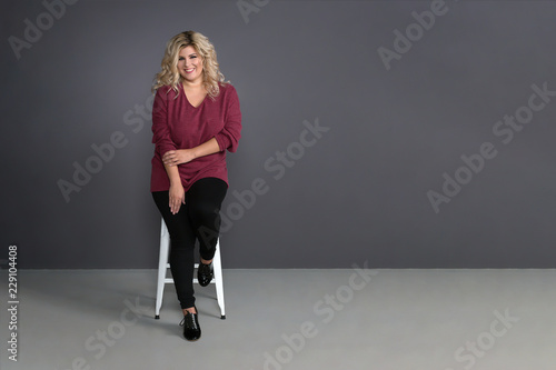 fat girl with a beautiful smile on a grey background
