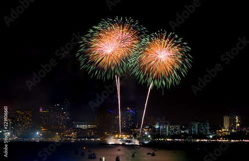 Fireworks explored over cityscape at night in sea port in Pattaya.Holiday festive celebration background.