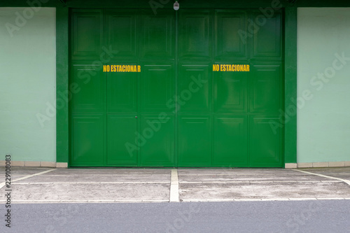 a green closed metal gate