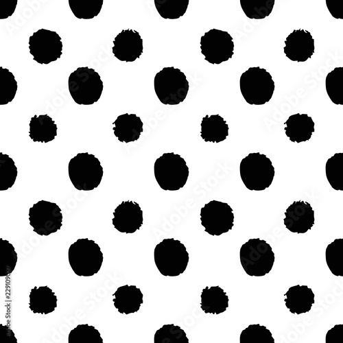 Abstract polka dot seamless pattern in hand drawn style with black dots on white background