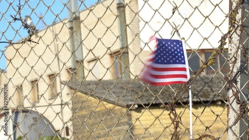 American flag on closed factory gates 4K