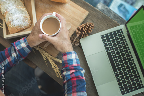 Man is coffee time and laptop is work.