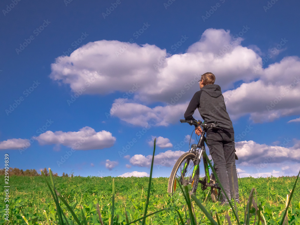 boy stand still and relax soul during bike tour boy stand still and relax soul during bike tour
