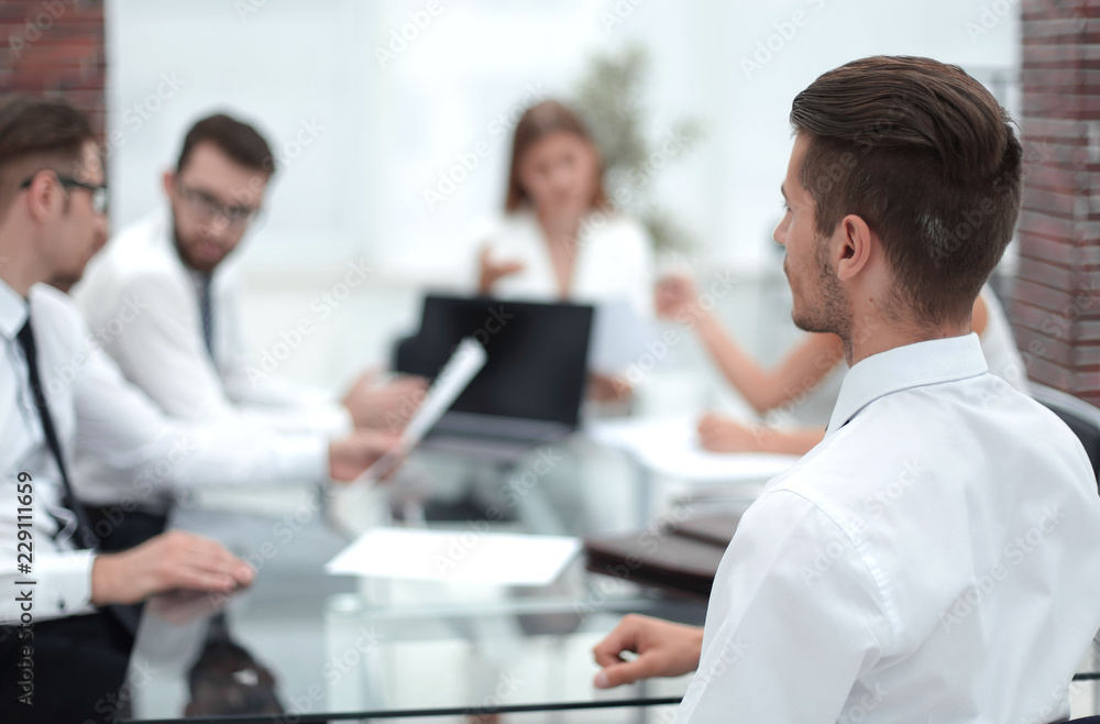 businessman sitting at his Desk at a working meeting businessman sitting at his Desk at a working meeting