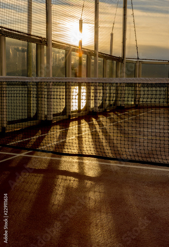 фотографія Tennis court net on a cruise ship in late afternoon sunlight.