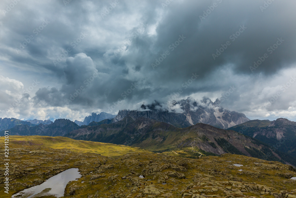 Beautiful summer scenery in the Dolomite Alps, Italy, with dramatic storm clouds