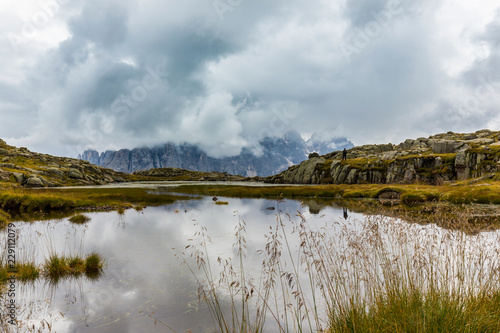 Fototapeta Naklejka Na Ścianę i Meble -  Clouds and mountain peaks reflection in the Dolomite Alps
