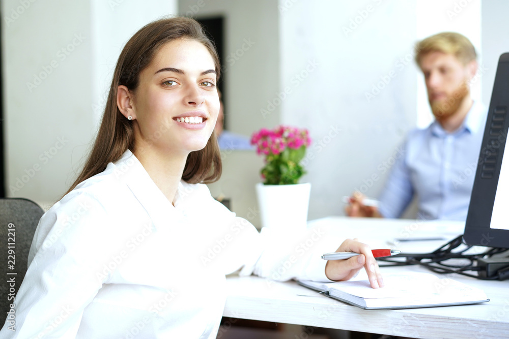 business woman with her staff, people group in background at modern bright office indoors. business woman with her staff, people group in background at modern bright office indoors.