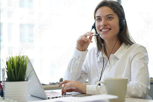 Wallpaper Mural Female customer support operator with headset and smiling. Torontodigital.ca