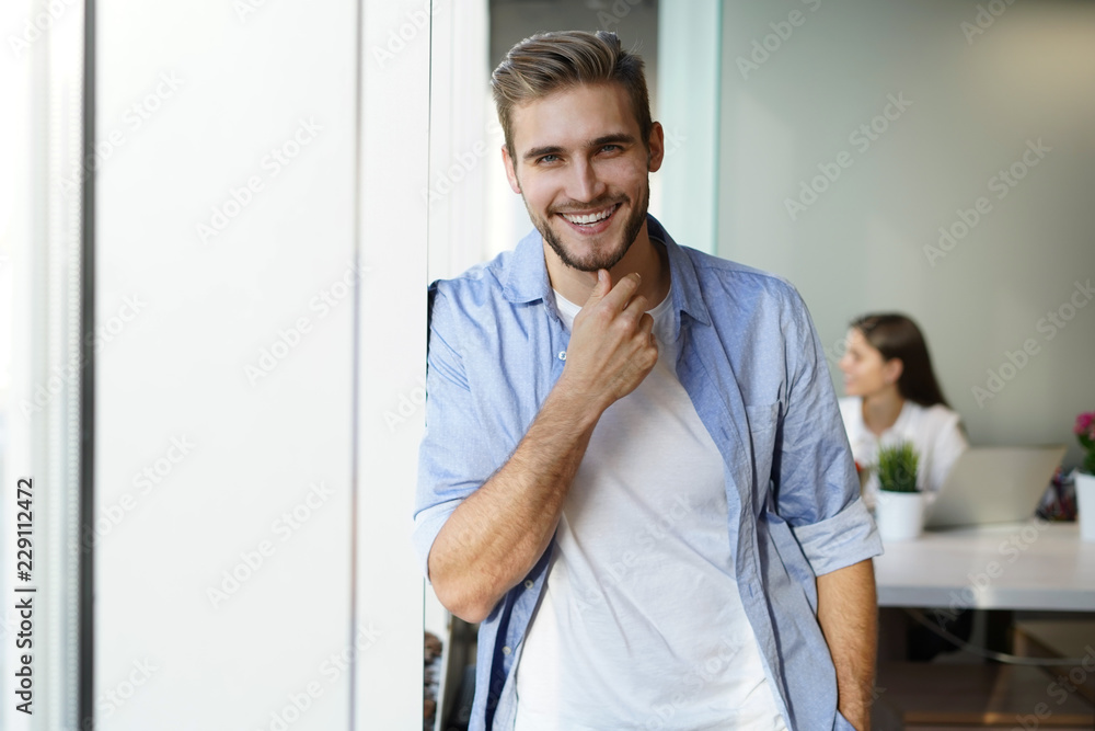 Portrait of a happy young casual businessman at office, smiling. Portrait of a happy young casual businessman at office, smiling.