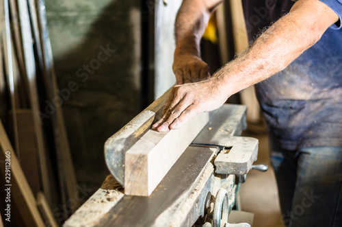 Carpenter tools on wooden table with sawdust. Cutting a wooden plank © Peruphotoart