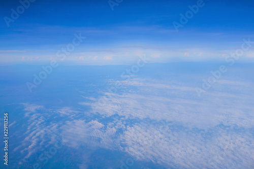 blue sky and white clouds with land from top view on air plain © khwanchai