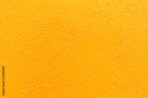 Stucco wall - Yellow stucco textured wall background with natural light.