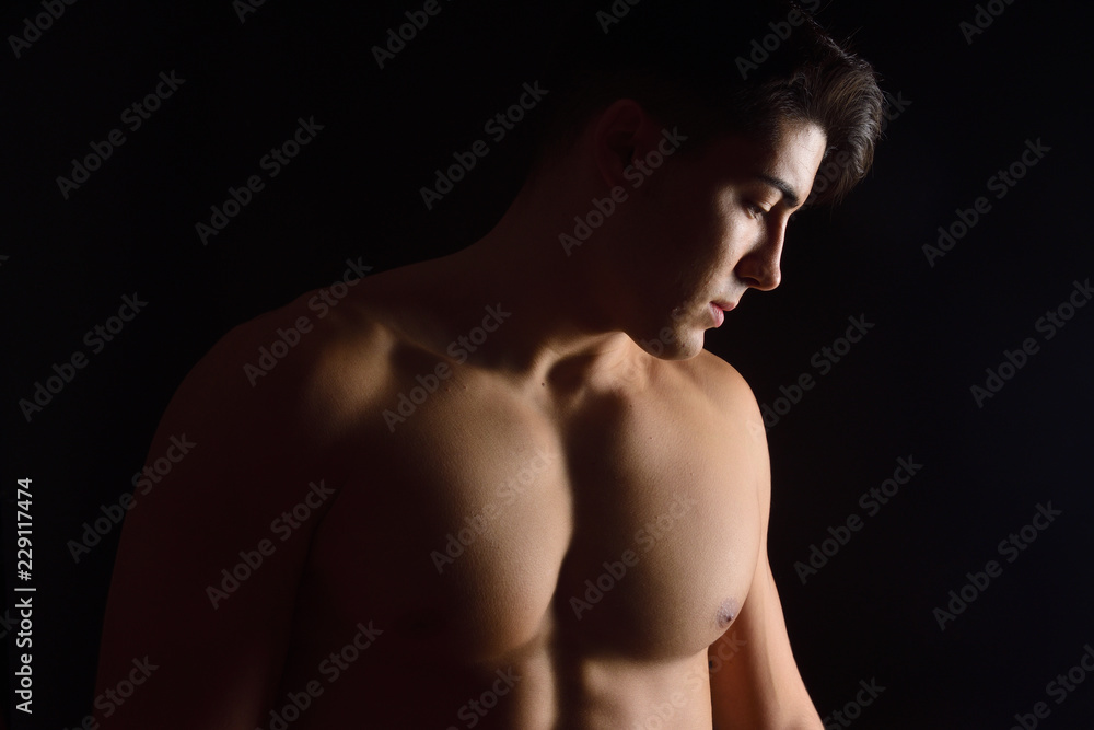 Fototapeta premium naked breast of a man on black background